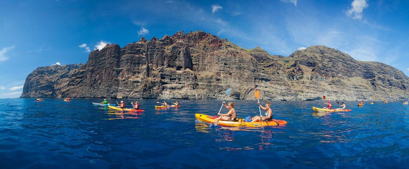 Kayaks with Los Gigantes Cliffs in the background