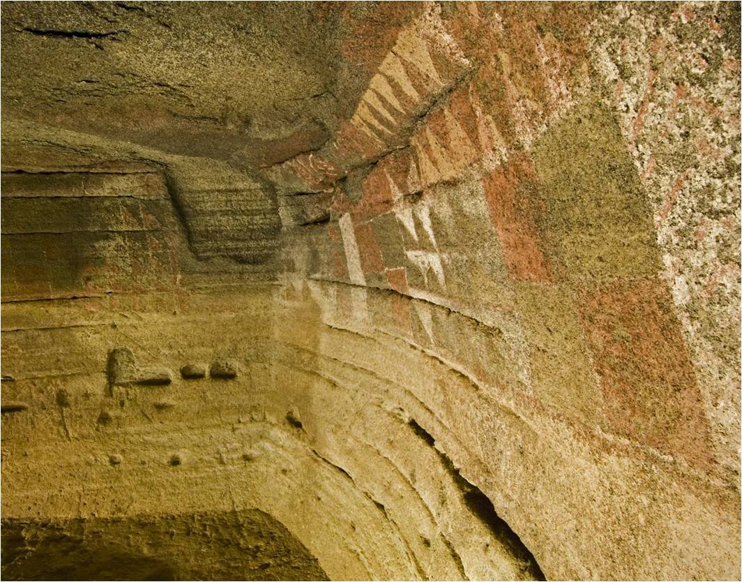 Red, white and black geometric paintings on the wall of the Cueva Pintada