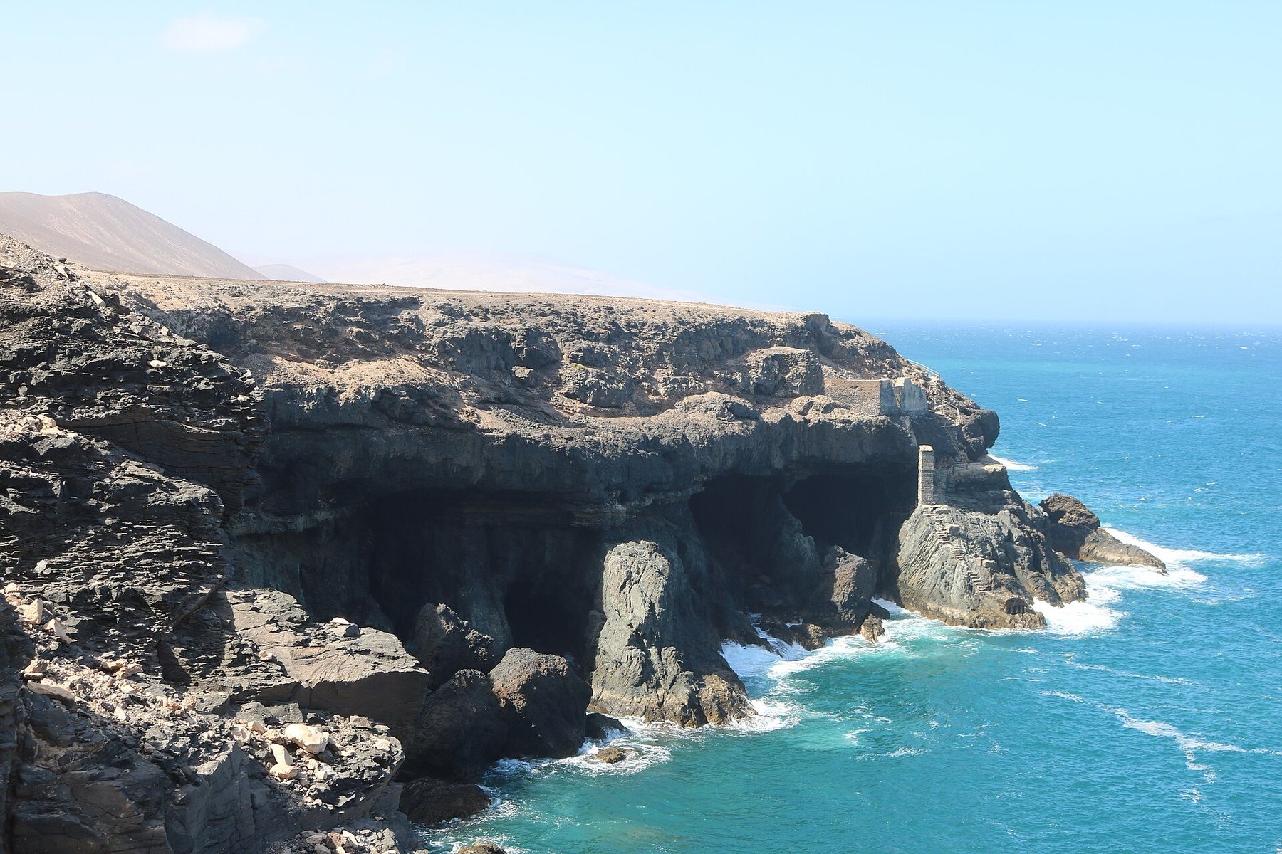 Ajuy caves cut into the cliff above the Atlantic