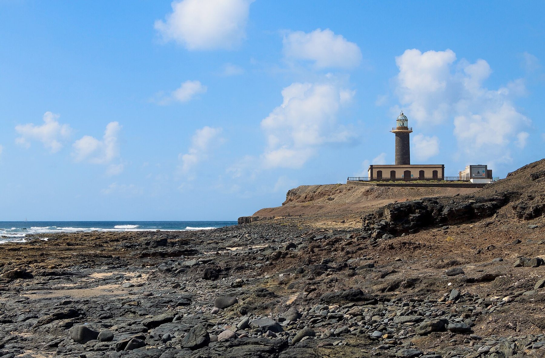 Punta de Jandía lighthouse on a lava cliff, Atlantic beyond